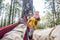 Cheerful woman with cup of coffe enjoy the nature relax outdoor leisure activity with man laying on the hammock - happy people in