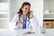 Cheerful woman doctor have phone conversation with patient