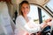 Cheerful woman driver in van campervan during vanlife lifestyle concept