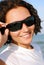 Cheerful woman face in black sunglasses