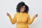 Cheerful woman with frizzy hairstyle dancing against white background