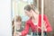 Cheerful woman with her daughter looking at a shower cabin