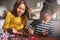 Cheerful woman holding beads for child at table