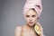 Cheerful woman holding pink towel on avocado head in hand exotic vitamins health cropped view