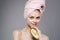 Cheerful woman holding pink towel on avocado head in hand exotic vitamins health cropped view