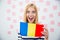 Cheerful woman holding Romanian flag