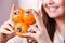 Cheerful woman holds persimmon kaki fruits