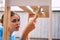 cheerful woman house painter repairing wooden structure