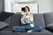 cheerful woman with a pillow in her hands on a sofa in an apartment interior Comfort