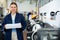 Cheerful woman printing shop manager holding ream of paper