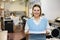 Cheerful woman printing shop manager holding ream of paper