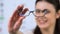 Cheerful woman proposing eyeglasses, patient recommendation, vision support