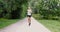 Cheerful woman running in park