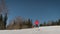 A Cheerful Woman Skis Down A Snowy Track At A Ski Resort And Dances Smiling