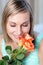 Cheerful woman smelling roses