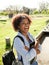 Cheerful Woman Standing Hands Folded On Campus