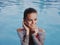 cheerful woman in a swimsuit in the pool smile close-up