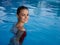 cheerful woman in a swimsuit in the pool smile luxury cosmetics
