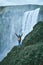 Cheerful woman walking and posing on nature in Iceland