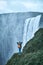 Cheerful woman walking and posing on nature in Iceland