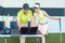 Cheerful woman watching her video recorded strike during a golf class