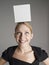 Cheerful Woman With White Box On Her Head