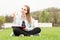 Cheerful woman writing in her journal and doing like gesture