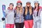 Cheerful women friends in sports winter clothes with skis posing