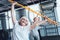 Cheerful women with stick doing side bending exercise at gym