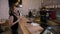 Cheerful worker serving female customers who use their smartphone app and bitcoin crypto currency to pay in a coffee shop -