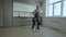 A Cheerful worker in uniform washes the floor in a new apartment