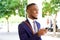 Cheerful young african businessman with cell phone