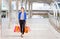 Cheerful young Asian woman carrying shopping bags while walking along the street. Shopping concepts