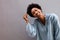 Cheerful young black woman with hand in hair