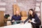 Cheerful young couple assembling furniture in the living room of new apartment