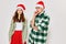 Cheerful young couple wearing new year`s clothes festive pipes mood