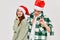 Cheerful young couple wearing new year`s clothes festive pipes mood new year