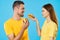 Cheerful young couple in yellow t-shirts hamburger fast food