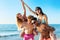 Cheerful young friends enjoying summertime on the beach