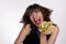 Cheerful young girl smiles and squeezes fresh lemons and limes