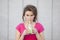 Cheerful young healthy teen woman drinking a green nutritional j