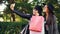 Cheerful young ladies shopaholics are taking selfie in the street holding bags and making funny faces. Women are wearing