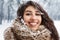 Cheerful Young Lady With Snow In Hair Smiling Standing In Forest