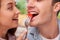 Cheerful young loving couple is eating in