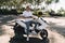 Cheerful young male traveler using remote UAV controller while sitting on motorbike