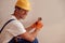 Cheerful young man fixing electrical wall socket