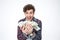 Cheerful young man holding bills of dollars