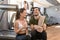 Cheerful young man and woman drinking plain water during break at the fitness