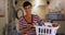 Cheerful young mom in her laundry room poses for portrait