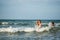 Cheerful young mother swims in the sea